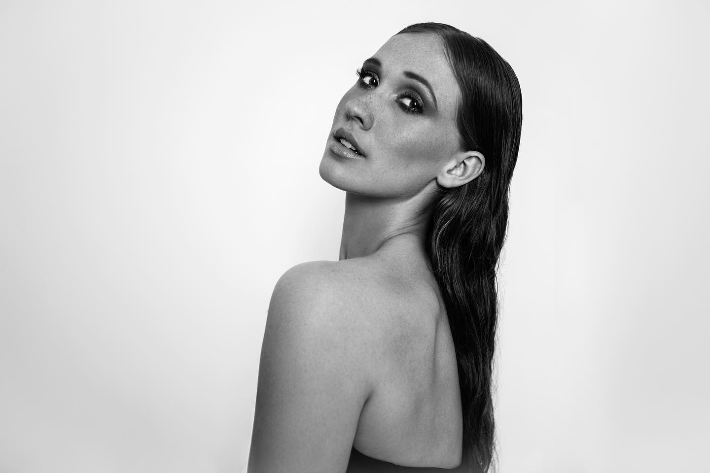 Black-and-white portrait of Marit glancing back over her shoulder