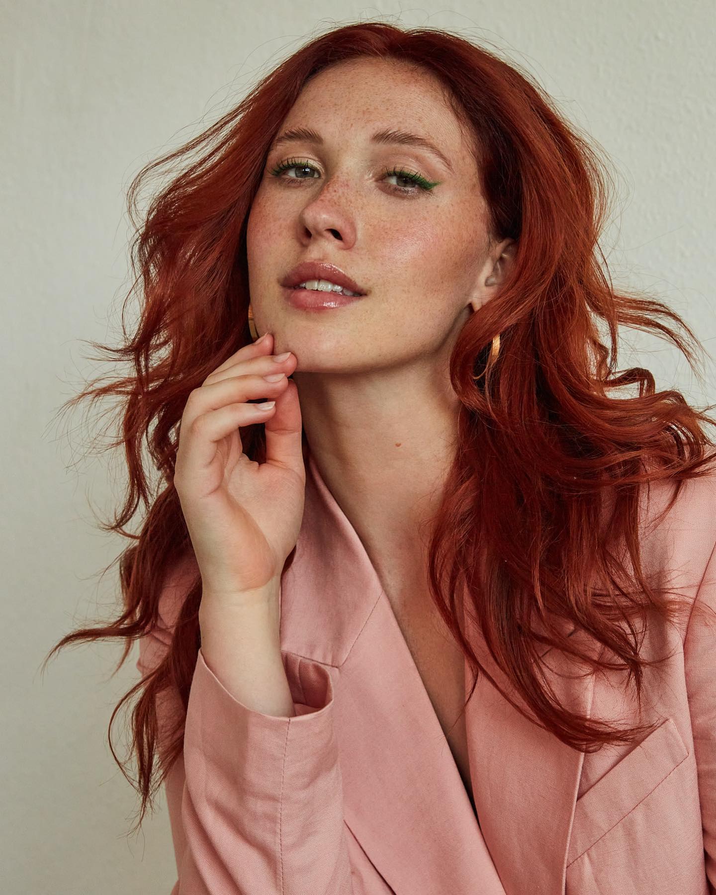 Beauty editorial, pink blazer with green eyeliner