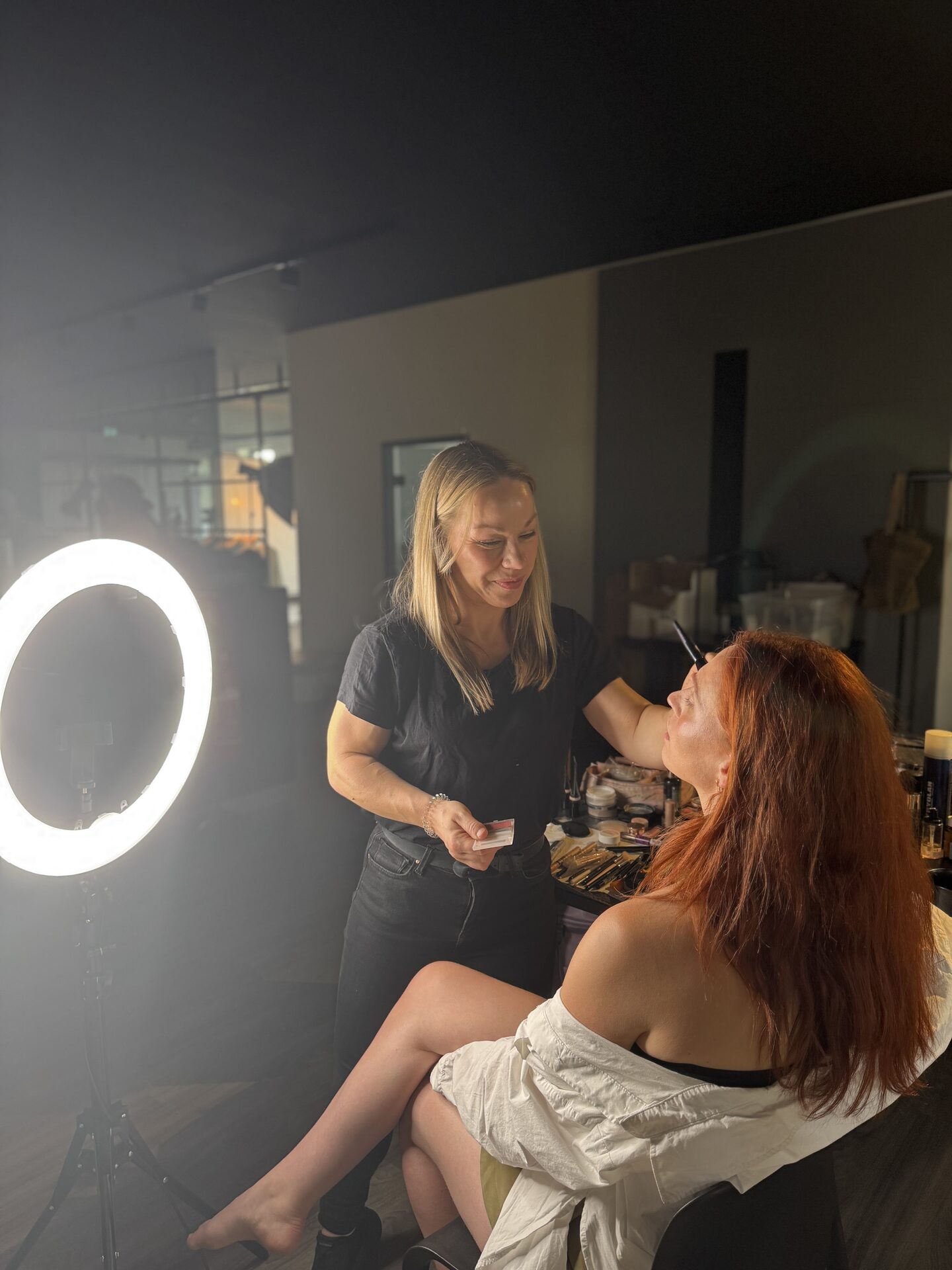 Marit backstage in front of a ring light during make-up